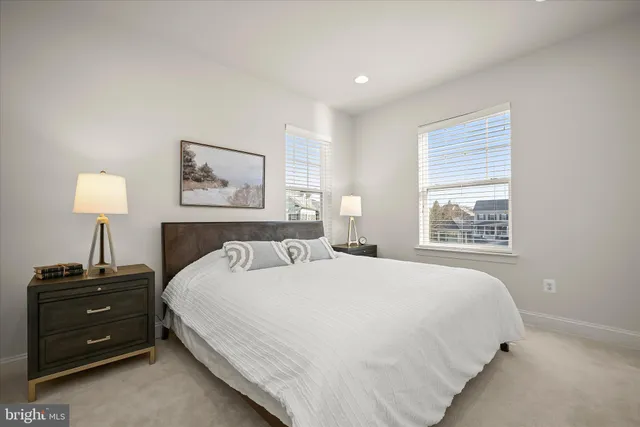 a bedroom with a bed and a night stand