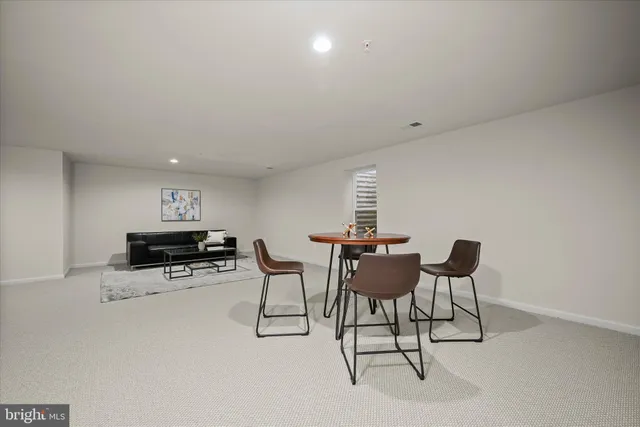 a view of a dining room with furniture and a chandelier