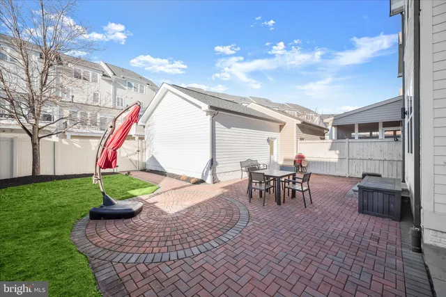 a view of a patio with a table and chairs