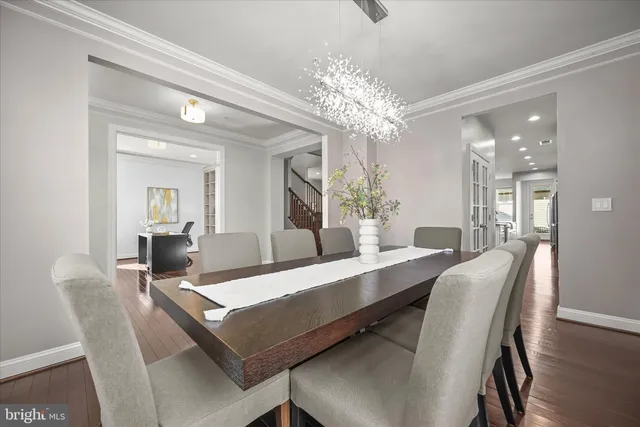 a view of a dining room with furniture and a chandelier
