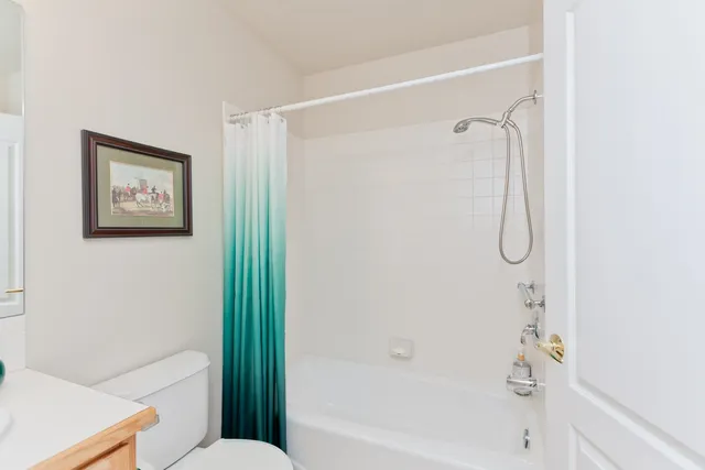 a bathroom with a shower and a toilet