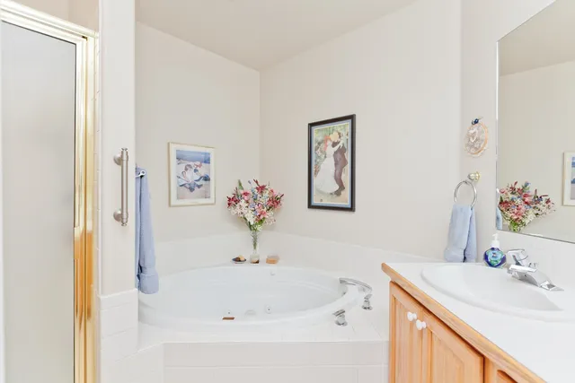 a white bath tub sitting next to a bathroom sink