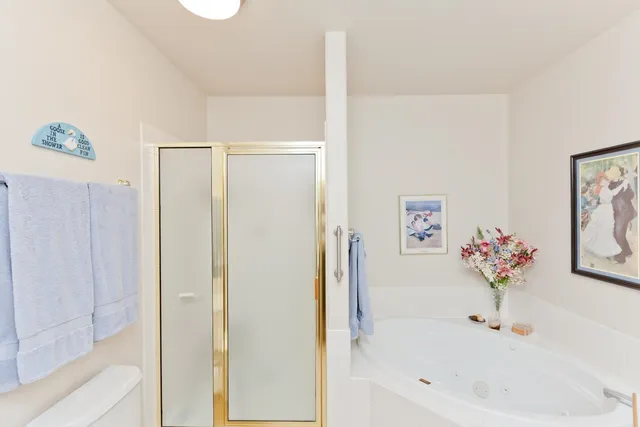 a white bath tub sitting next to a white sink