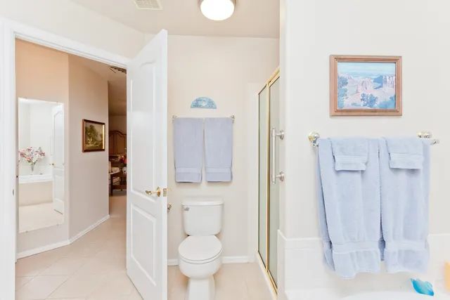 a bathroom with a toilet sink and shower