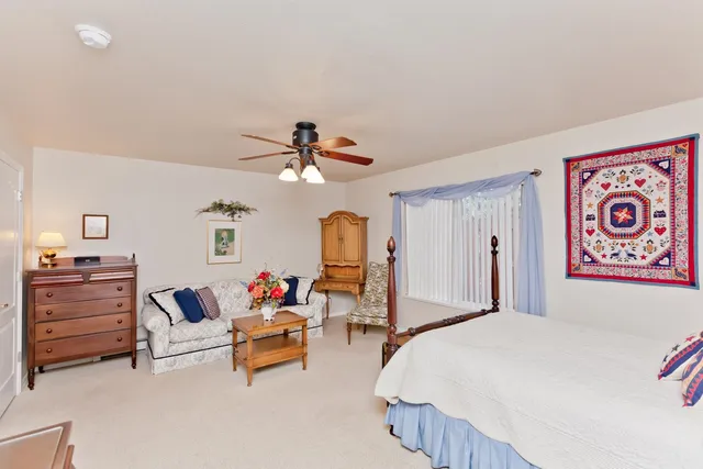 a bedroom with furniture and a chandelier