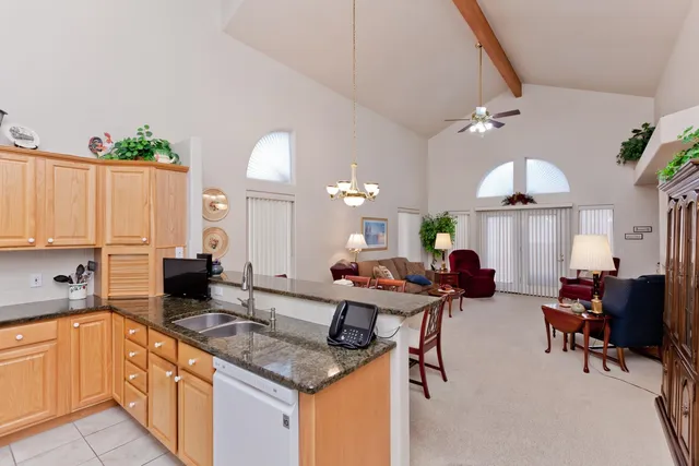 a large kitchen with a table chairs and a refrigerator