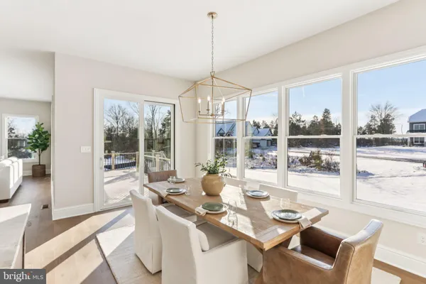 a large kitchen with a table chairs refrigerator and cabinets