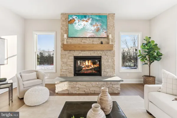 a living room with furniture a fireplace and a table