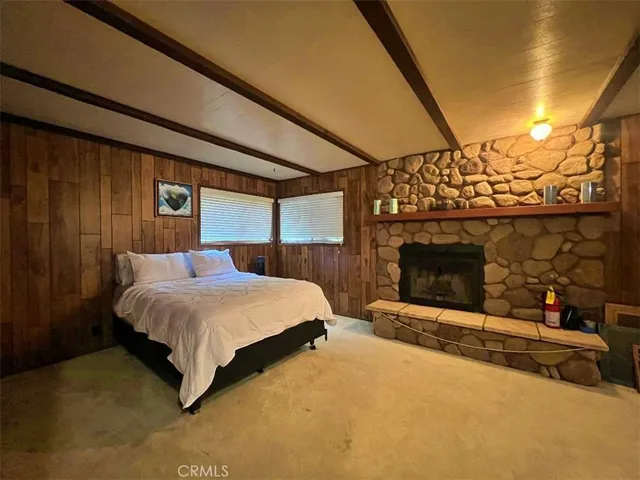 a spacious bedroom with a bed and a fireplace