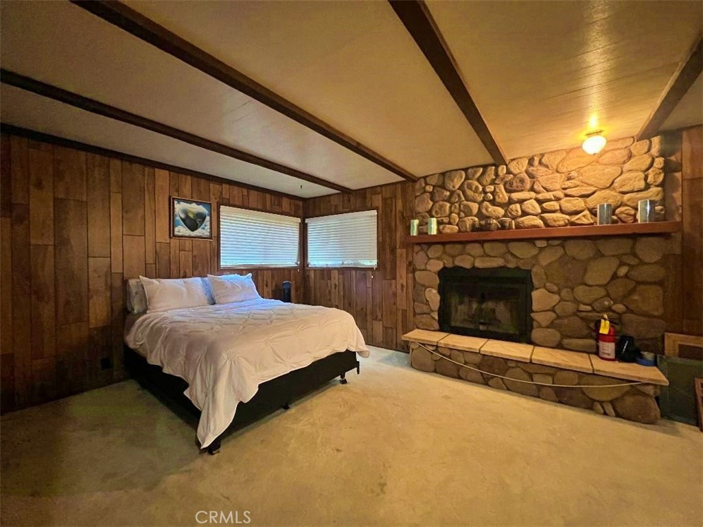 1198 Arbula Drive Crestline, CA 92325 - Photo 16 of 27 a spacious bedroom with a bed and a fireplace