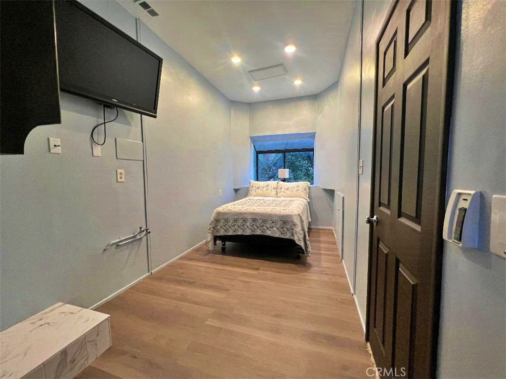 1198 Arbula Drive Crestline, CA 92325 - Photo 21 of 27 a bedroom with a bed and a flat screen tv