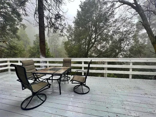a view of a terrace with furniture and wooden floor