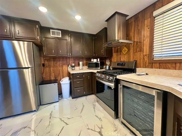 a kitchen with a refrigerator sink and stove