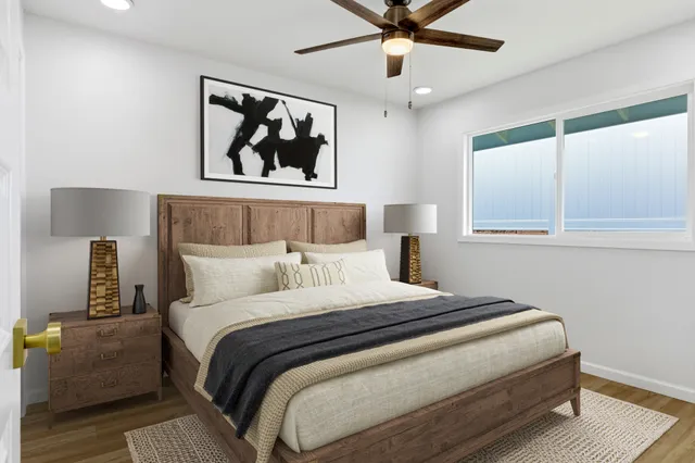 a bedroom with a large bed and a window