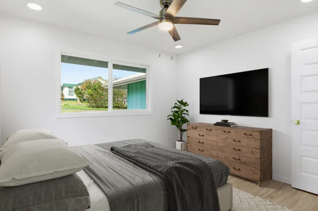 a bedroom with a bed and a flat screen tv