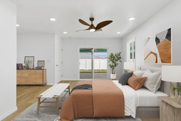 a bedroom with a large bed and a window