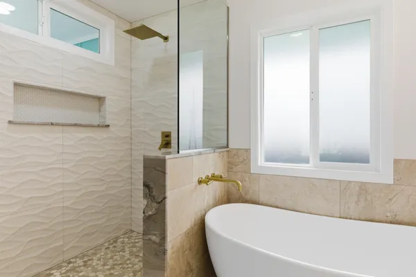 a white bath tub sitting next to a window