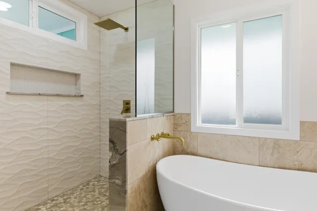 a white bath tub sitting next to a window