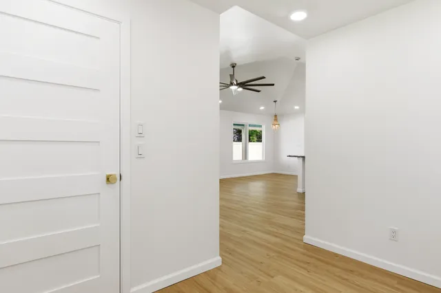 a view of empty room with wooden floor