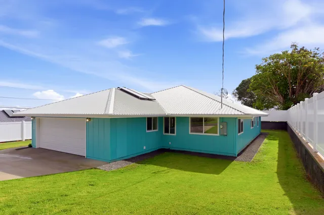 a view of an house with backyard space and balcony
