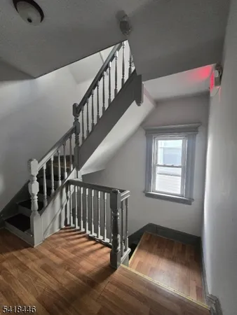 a view of staircase with white walls and a window