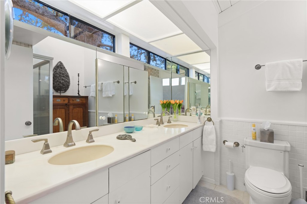 300 Emerald Bay Laguna Beach, CA 92651 - Photo 13 of 31 a bathroom with a granite countertop sink mirror and toilet