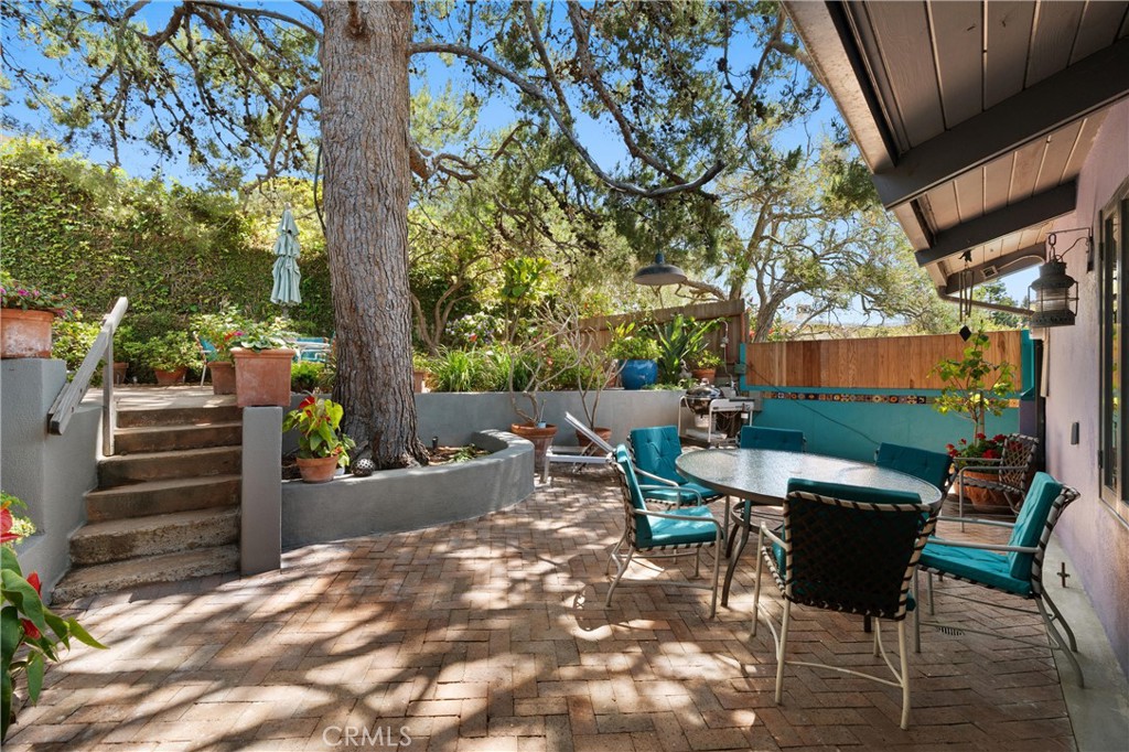 300 Emerald Bay Laguna Beach, CA 92651 - Photo 23 of 31 a view of a patio with table and chairs and potted plants