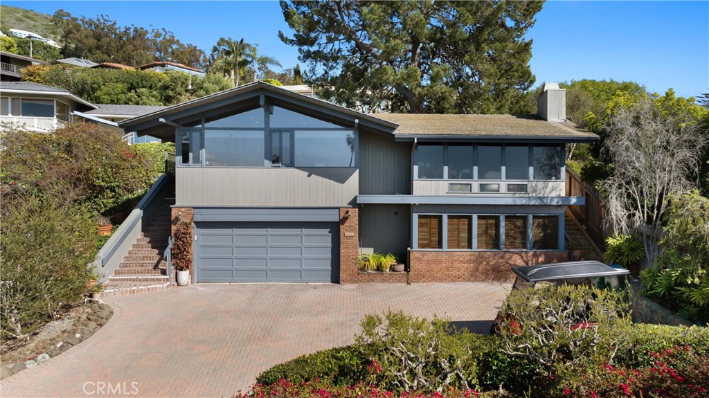 300 Emerald Bay Laguna Beach, CA 92651 - Photo 4 of 31 a front view of a house with a yard and garage