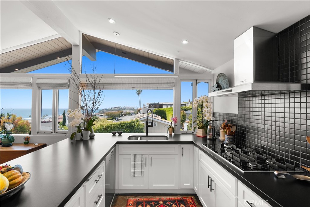 300 Emerald Bay Laguna Beach, CA 92651 - Photo 5 of 31 a kitchen with stainless steel appliances a sink a stove and a wooden cabinets