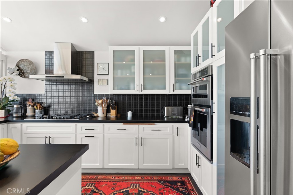 300 Emerald Bay Laguna Beach, CA 92651 - Photo 6 of 31 a kitchen with granite countertop a refrigerator a stove and a sink