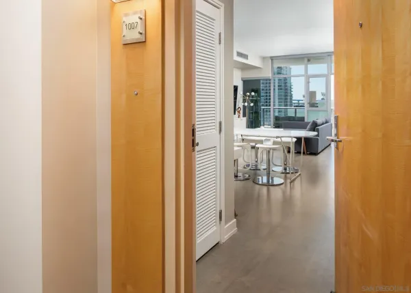 a hallway with a dining table and chairs