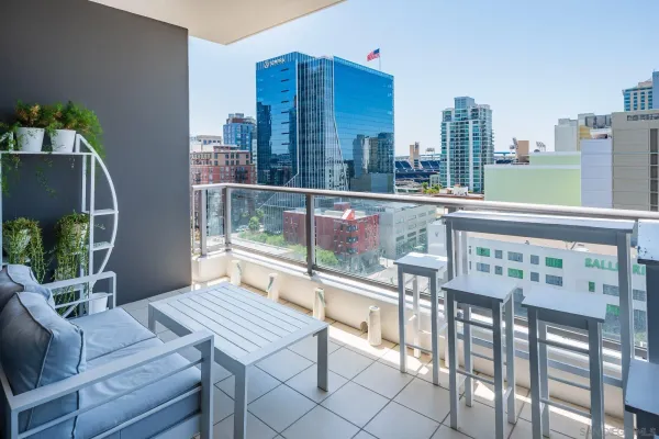 a roof deck with table and chairs