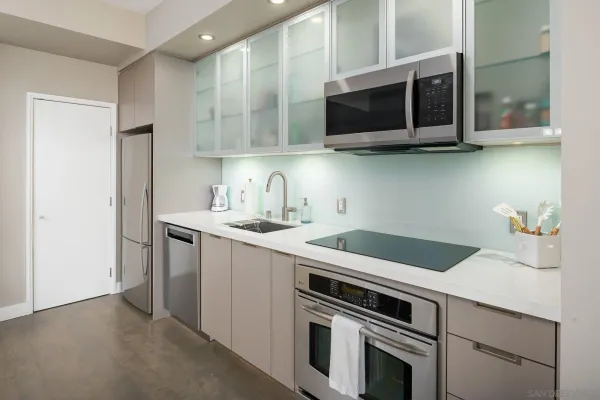 a kitchen with stainless steel appliances a stove a microwave sink and cabinets