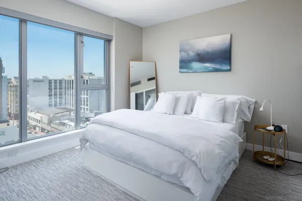 a bedroom with a large bed and a window