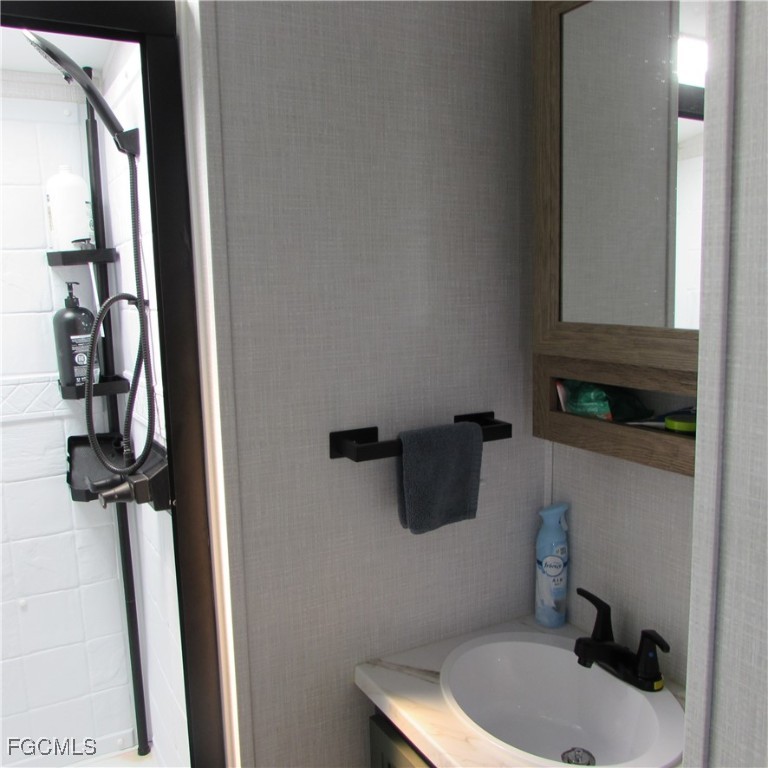 19681-313 Summerlin Road Fort Myers, FL 33908 - Photo 19 of 40 a bathroom with a sink and a mirror