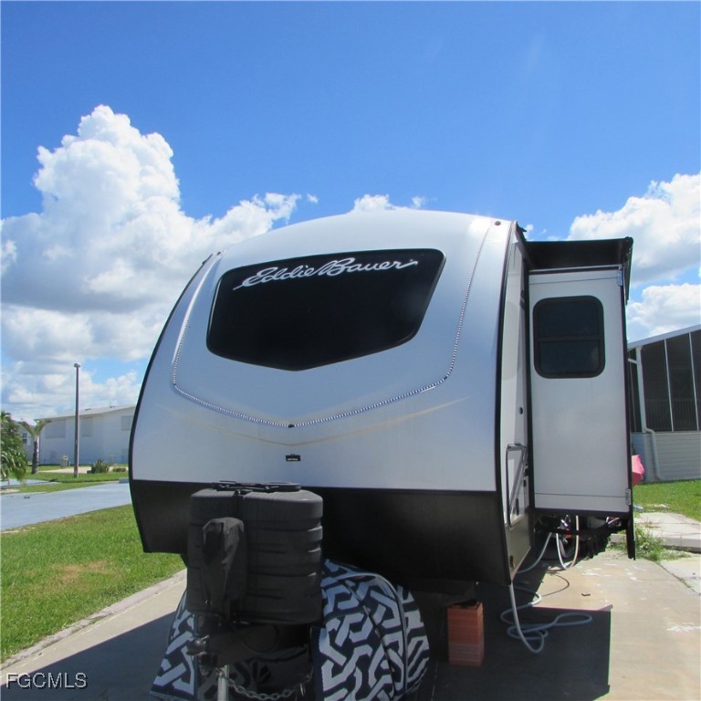 19681-313 Summerlin Road Fort Myers, FL 33908 - Photo 2 of 40 a front view of a house with garden