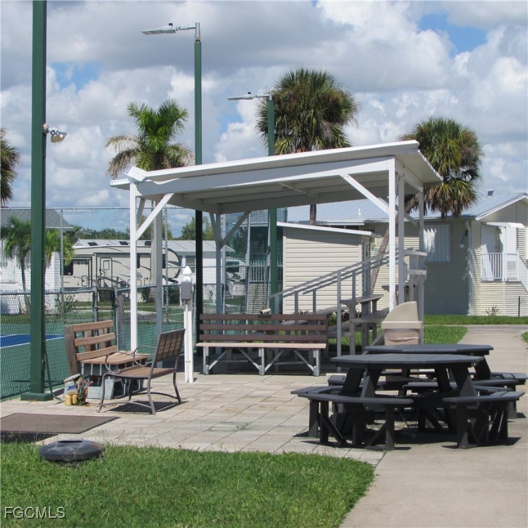 19681-313 Summerlin Road Fort Myers, FL 33908 - Photo 27 of 40 a view of a house with backyard sitting area and garden
