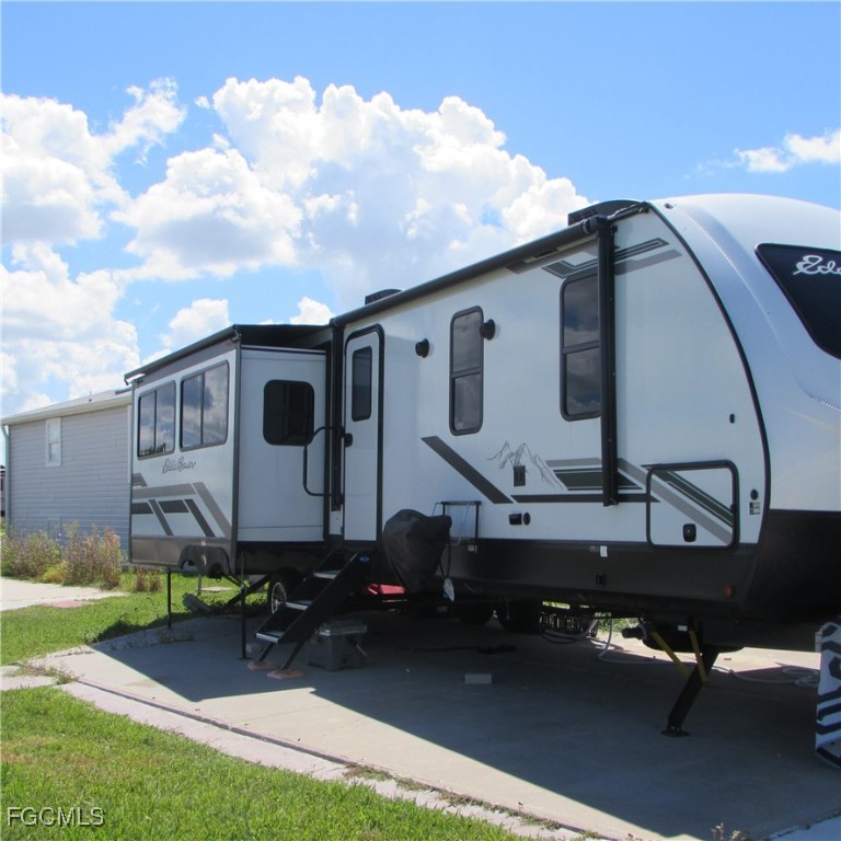 19681-313 Summerlin Road Fort Myers, FL 33908 - Photo 3 of 40 a front view of a house with garden