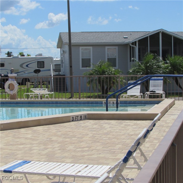 19681-313 Summerlin Road Fort Myers, FL 33908 - Photo 31 of 40 a view of a swimming pool with a chair