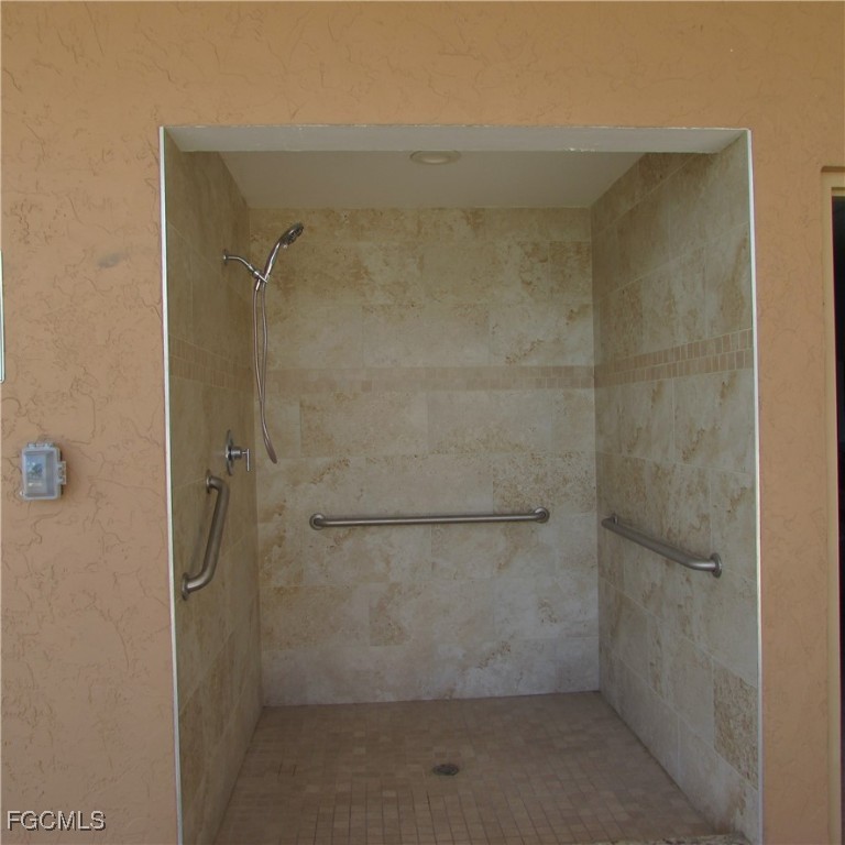 19681-313 Summerlin Road Fort Myers, FL 33908 - Photo 32 of 40 a bathroom with a glass door shower