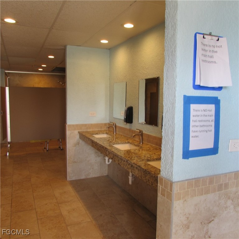 19681-313 Summerlin Road Fort Myers, FL 33908 - Photo 33 of 40 a bathroom with a sink and a mirror