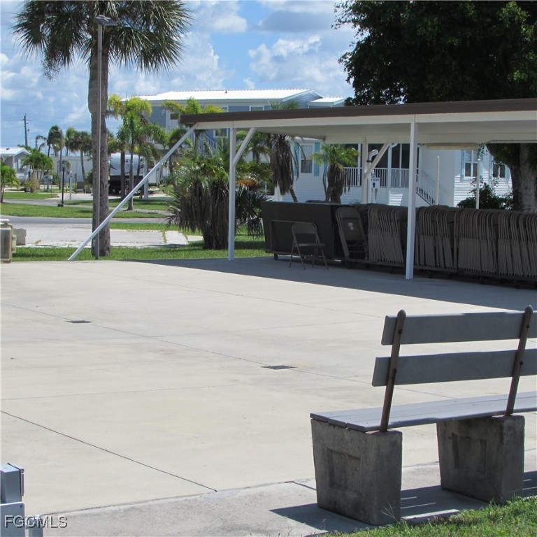 19681-313 Summerlin Road Fort Myers, FL 33908 - Photo 36 of 40 a front view of a house with a yard and potted plants