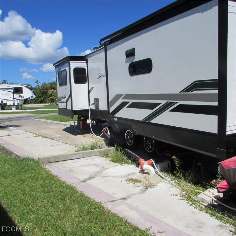 19681-313 Summerlin Road Fort Myers, FL 33908 - Photo 9 of 40 a backyard of a house with barbeque oven and outdoor seating