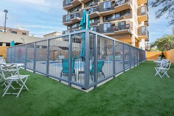 a view of a chair and table in the backyard