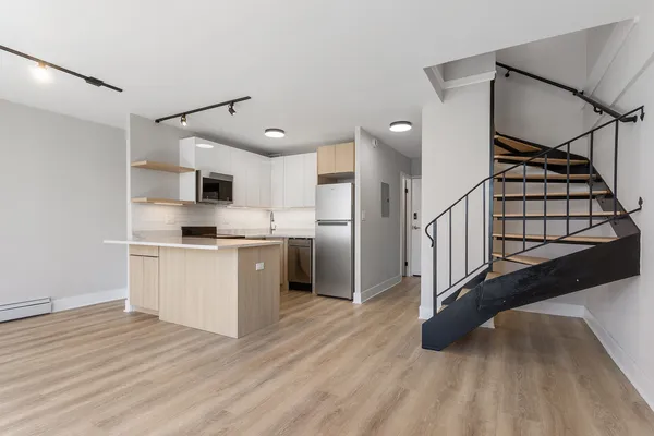 a kitchen with white cabinets and white appliances