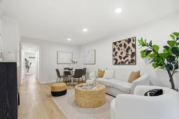 a living room with furniture and a potted plant
