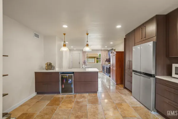 a large kitchen with a counter space a sink stainless steel appliances and cabinets
