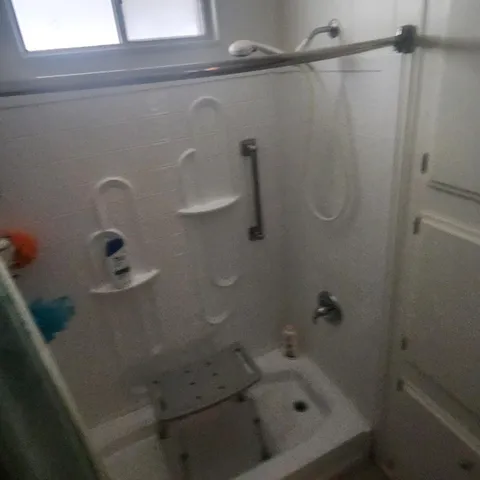 a bedroom with bed and a chandelier