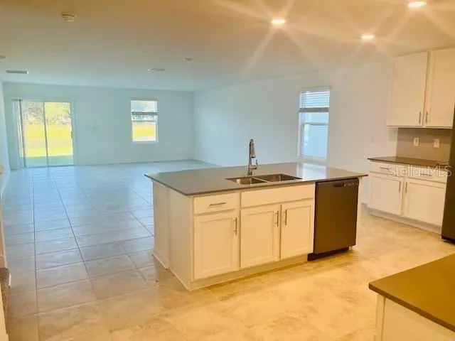 a kitchen with a sink cabinets and window