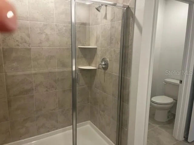 a bathroom with a shower and a toilet